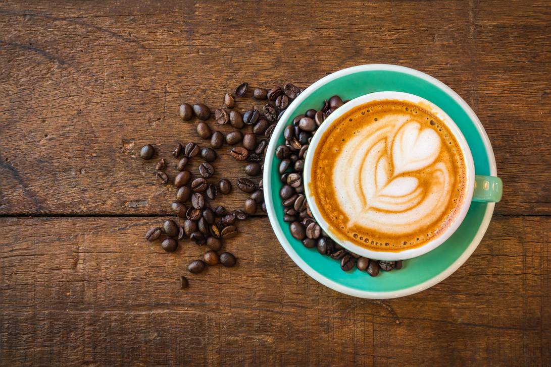 Latte hot coffee and roasted coffee beans.