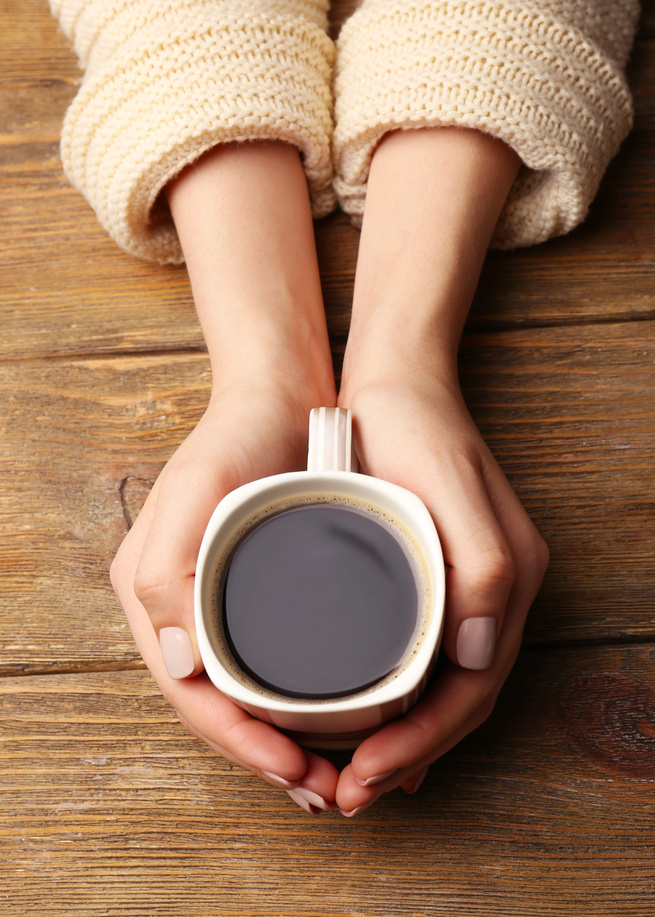 Woman Holding a Cup of Coffee